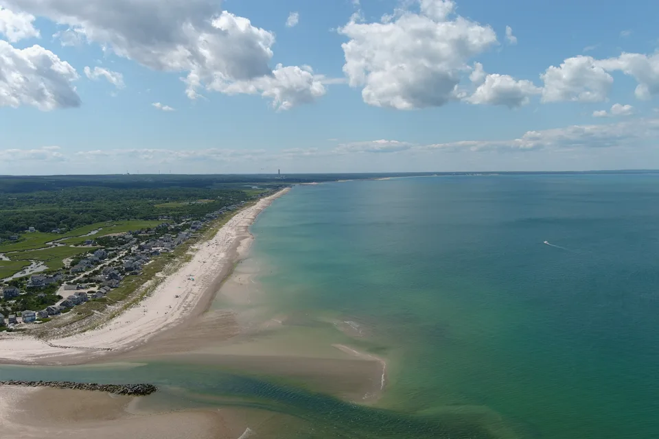 A hazy Cape Cod shoreline stretching toward the horizon